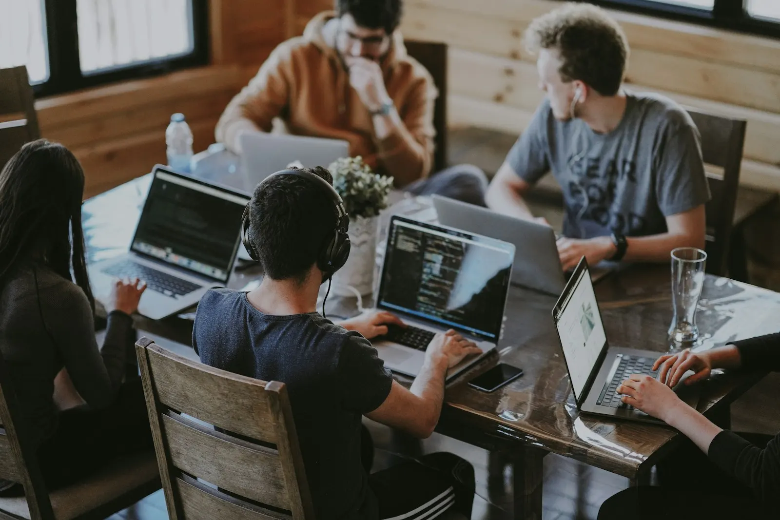 Team members working together around a large table